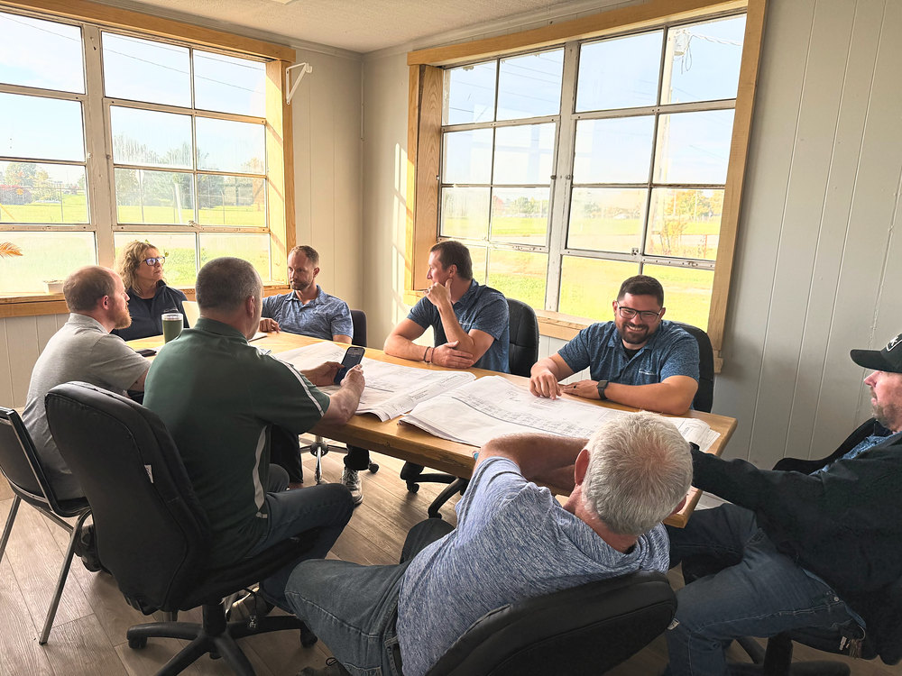 The Triumph team reviewing a project around a conference table