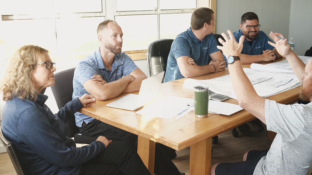 Team members reviewing plans together at a table