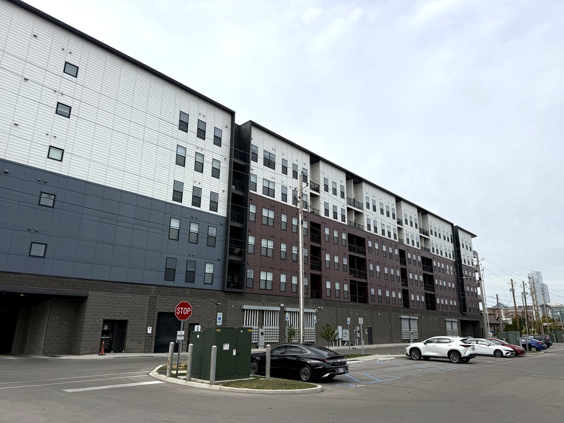 Rear elevation of Rise on Meridian in Indianapolis, a multi-story building above a ground-level parking area